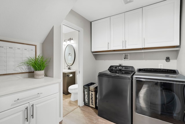 3423 Velasco Ct, Missouri City, TX 77459 - laundry room with cabinet space and washer and clothes dryer