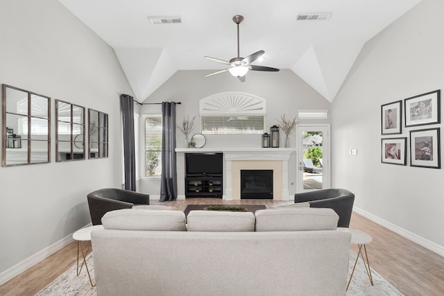 3423 Velasco Ct, Missouri City, TX 77459 - living room with healthy amount of natural light, a fireplace, ceiling fan, light wood-style flooring, and lofted ceiling