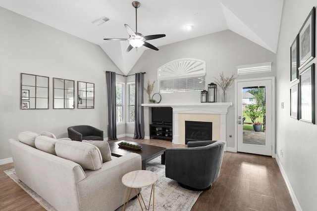 3423 Velasco Ct, Missouri City, TX 77459 - living room with lofted ceiling, ceiling fan, a tiled fireplace, and wood finished floors