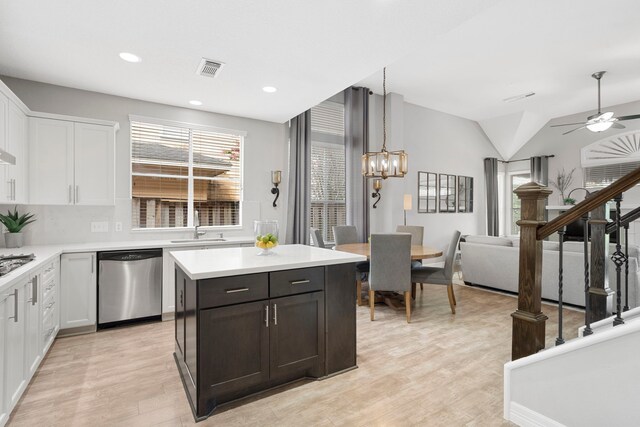 3423 Velasco Ct, Missouri City, TX 77459 - kitchen featuring stainless steel appliances, light countertops, light wood finished floors, white cabinetry, and ceiling fan