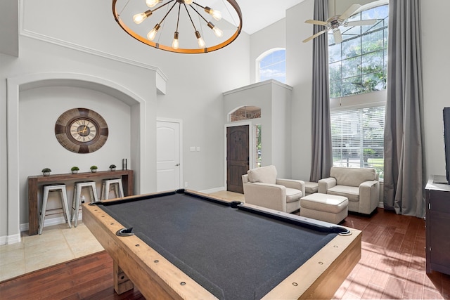 3423 Velasco Ct, Missouri City, TX 77459 - playroom featuring billiards table, a high ceiling, dark wood-style flooring, a chandelier, and ceiling fan