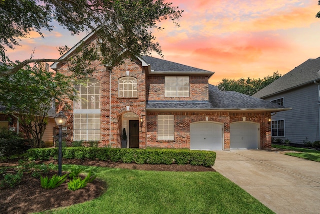 3423 Velasco Ct, Missouri City, TX 77459 - view of front facade with driveway, a garage, brick siding, and a shingled roof