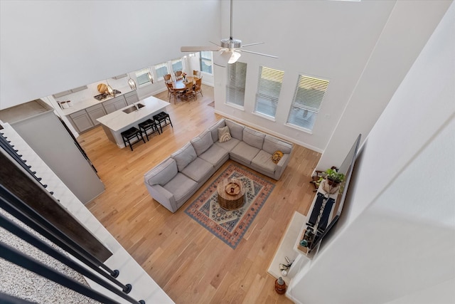 10059 Preserve Way, Conroe, TX 77385 - living area featuring a towering ceiling, light wood finished floors, and a ceiling fan