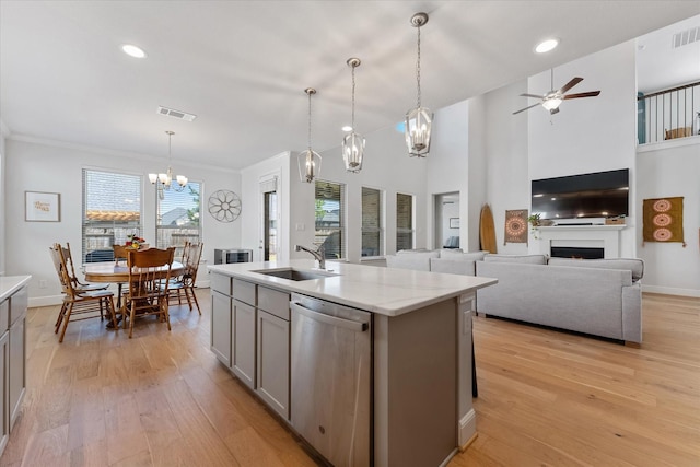 10059 Preserve Way, Conroe, TX 77385 - kitchen featuring dishwasher, gray cabinetry, a chandelier, ceiling fan, and light wood-style floors