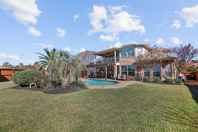 18815 Manleigh Ct, Tomball, TX 77377 - back of property with a balcony, brick siding, a patio area, an outdoor pool, and a chimney
