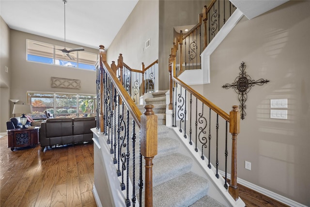 18815 Manleigh Ct, Tomball, TX 77377 - staircase featuring wood finished floors and a towering ceiling