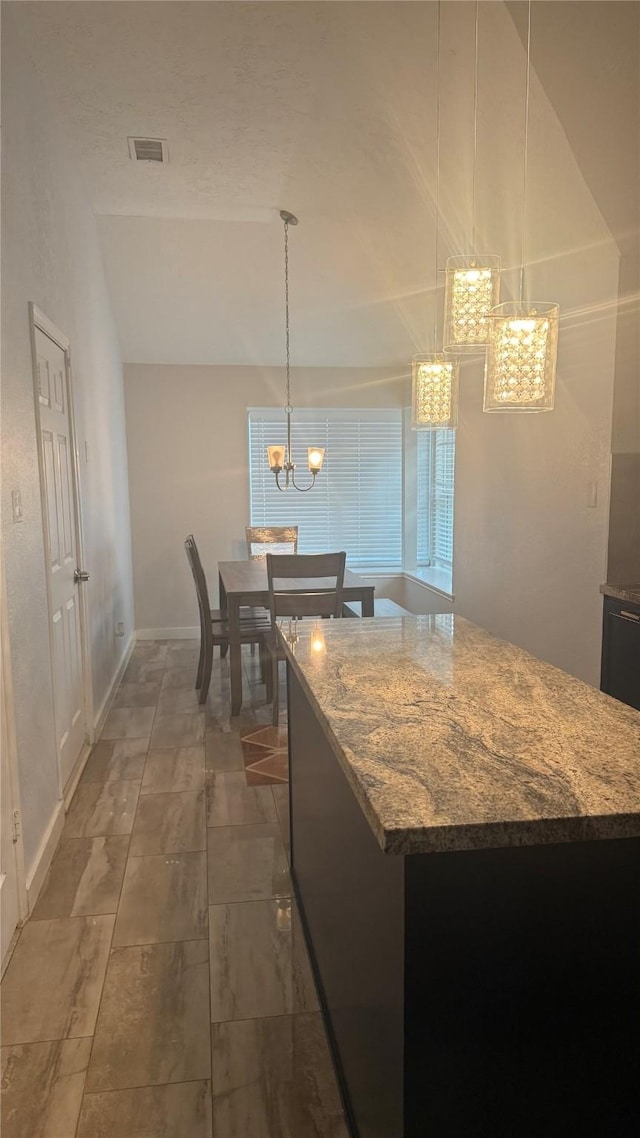 6018 Beaconridge Dr, Houston, TX 77053 - kitchen featuring a chandelier, light stone countertops, and decorative light fixtures