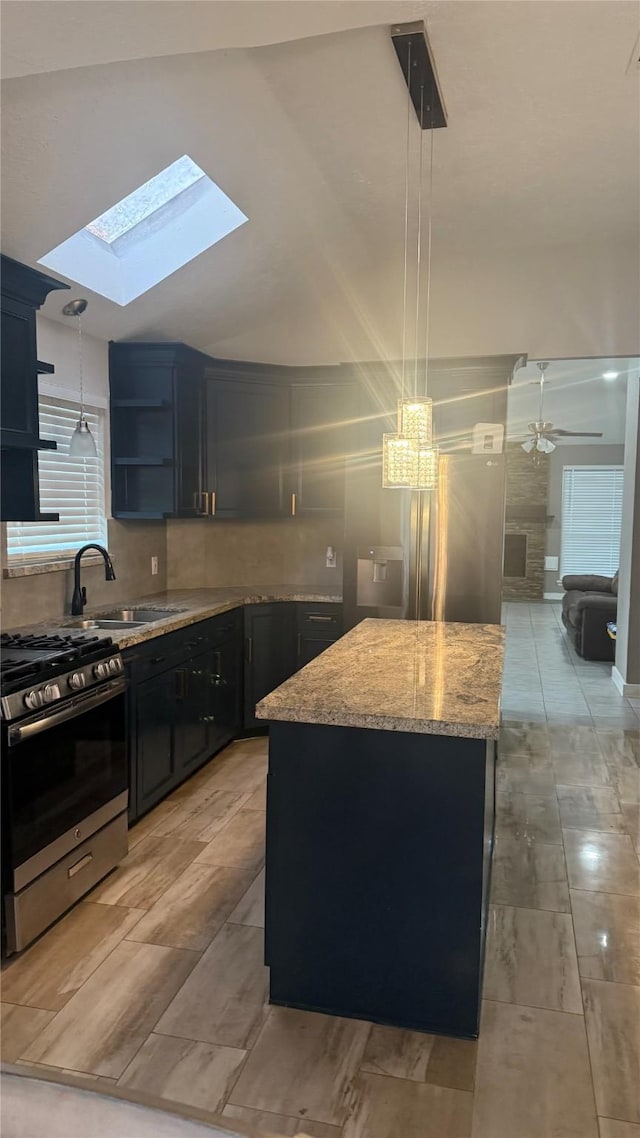 6018 Beaconridge Dr, Houston, TX 77053 - kitchen featuring stainless steel gas range, a center island, light stone countertops, open shelves, and a skylight