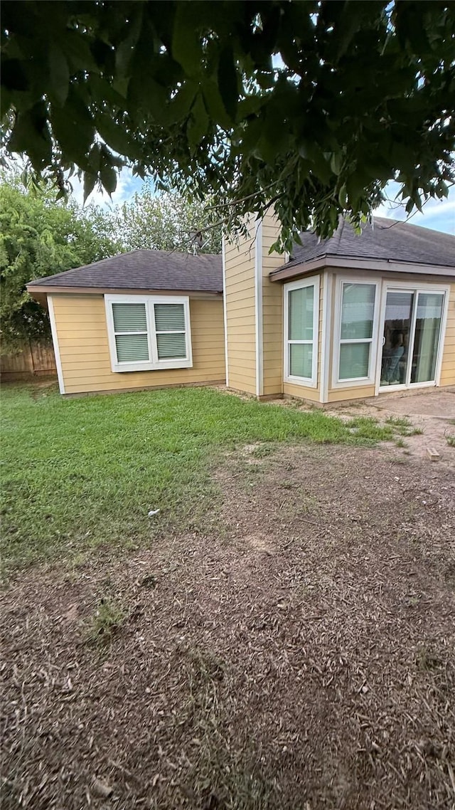 6018 Beaconridge Dr, Houston, TX 77053 - view of side of home featuring a yard and roof with shingles