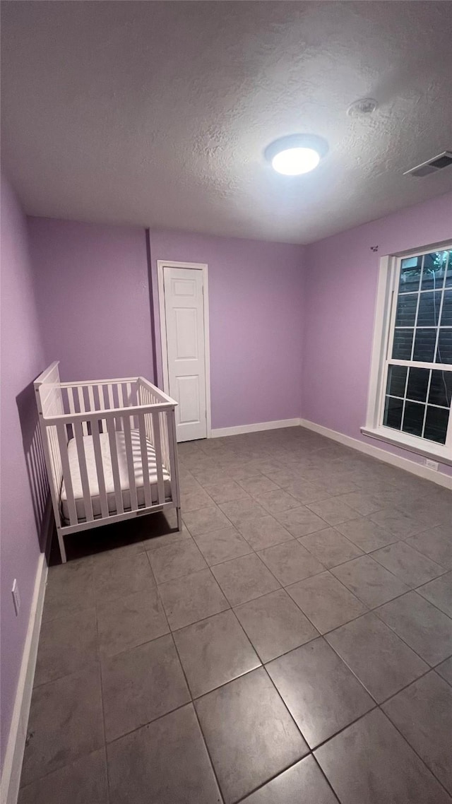 6018 Beaconridge Dr, Houston, TX 77053 - unfurnished bedroom featuring a textured ceiling and tile patterned floors