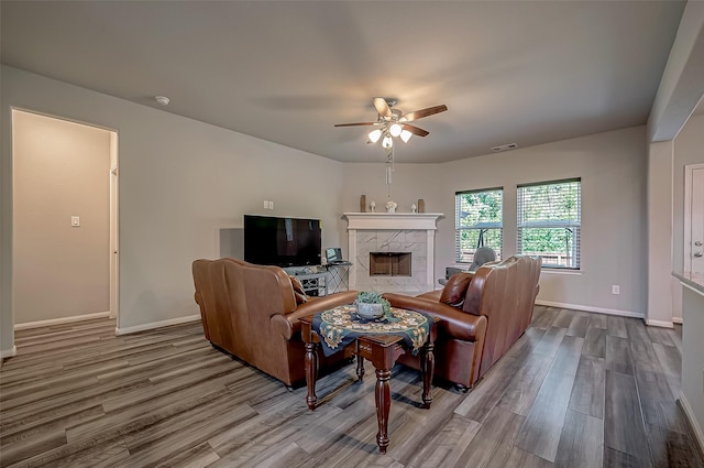 15055 Meadow Gln N, Conroe, TX 77306 - living area featuring wood finished floors, a high end fireplace, and ceiling fan