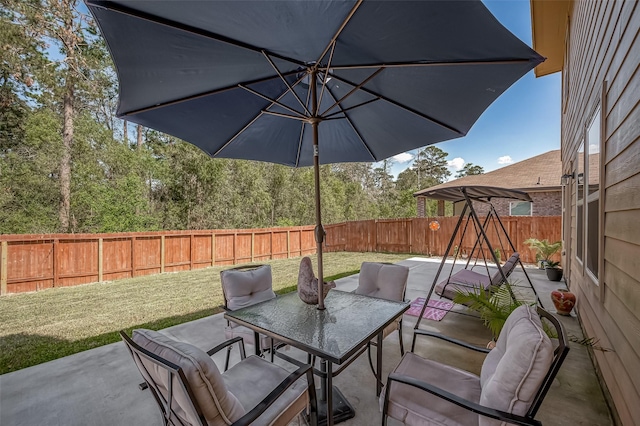 15055 Meadow Gln N, Conroe, TX 77306 - fenced backyard with outdoor dining space and a patio