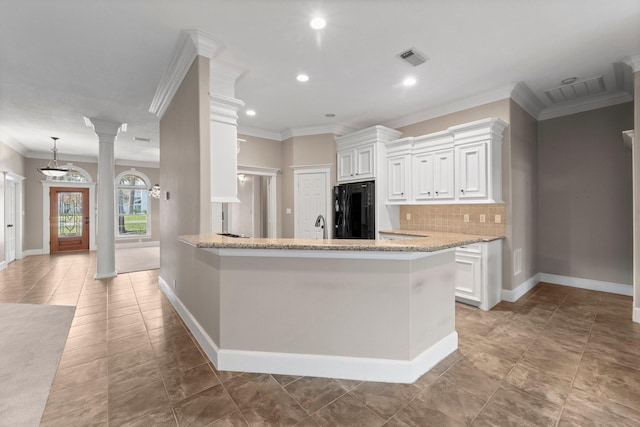 11510 Walden Rd, Montgomery, TX 77356 - kitchen with black refrigerator, backsplash, ornamental molding, white cabinetry, and light stone countertops