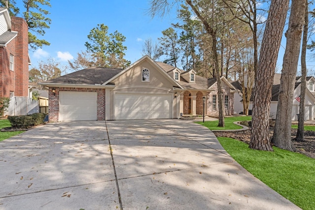 11510 Walden Rd, Montgomery, TX 77356 - traditional home featuring brick siding, concrete driveway, a garage, and roof with shingles