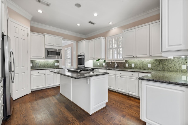 3908 Milton St, West University Place, TX 77005 - kitchen with stainless steel appliances, ornamental molding, white cabinetry, backsplash, and recessed lighting