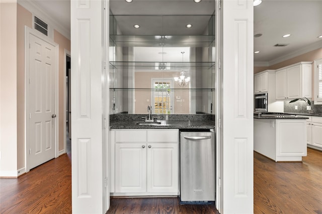 3908 Milton St, West University Place, TX 77005 - indoor wet bar featuring ornamental molding, dark wood-style flooring, stainless steel oven, and recessed lighting