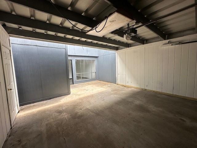 9009 Imogene St Unit E, Houston, TX 77036 - garage featuring a garage door opener and wooden walls