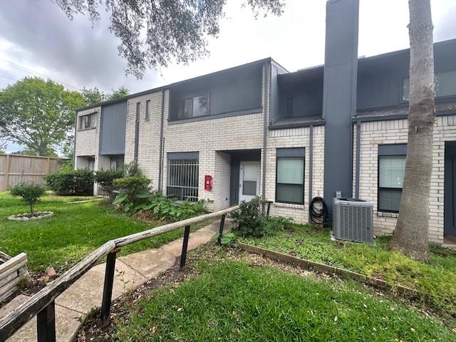 9009 Imogene St Unit E, Houston, TX 77036 - rear view of property featuring brick siding