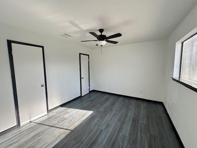 9009 Imogene St Unit E, Houston, TX 77036 - unfurnished bedroom with dark wood-style floors and a ceiling fan