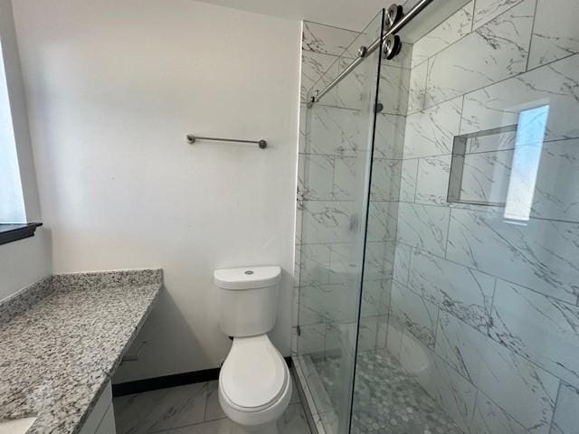 9009 Imogene St Unit E, Houston, TX 77036 - bathroom featuring marble look tiles, vanity, and a shower stall
