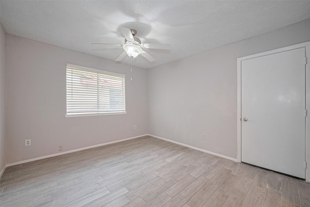 10423 Rancho Bernardo Ln, Sugar Land, TX 77498 - empty room with light wood-type flooring, ceiling fan, and a textured ceiling
