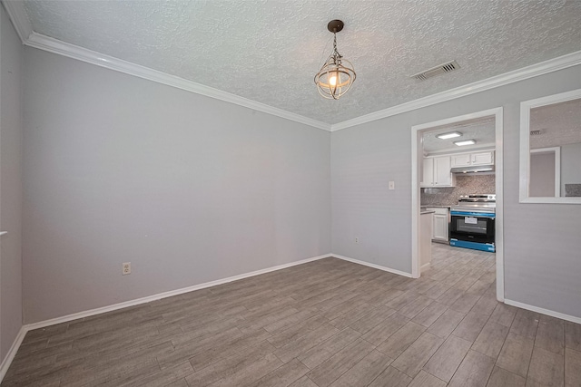10423 Rancho Bernardo Ln, Sugar Land, TX 77498 - spare room with wood finished floors, a textured ceiling, and ornamental molding