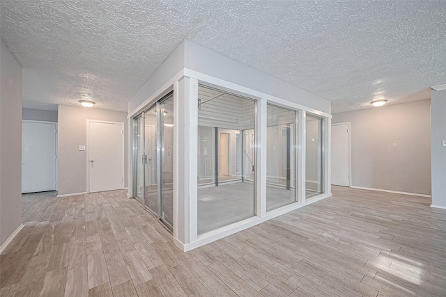 10423 Rancho Bernardo Ln, Sugar Land, TX 77498 - corridor featuring light wood finished floors and a textured ceiling