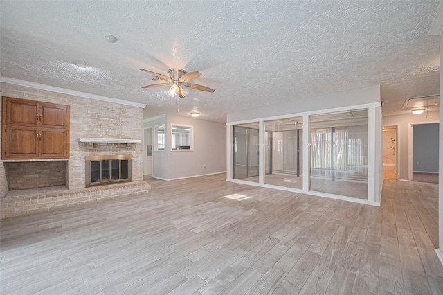 10423 Rancho Bernardo Ln, Sugar Land, TX 77498 - unfurnished living room with ceiling fan, a textured ceiling, light wood-type flooring, and a fireplace