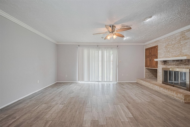 10423 Rancho Bernardo Ln, Sugar Land, TX 77498 - unfurnished living room featuring ceiling fan, light wood-style floors, a textured ceiling, a fireplace, and crown molding