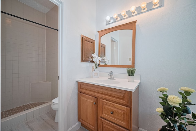9302 Moorfield Ct, Houston, TX 77083 - bathroom with vanity, a tile shower, and wood finished floors
