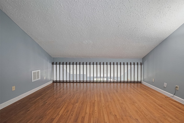9302 Moorfield Ct, Houston, TX 77083 - additional living space featuring a textured ceiling and wood finished floors
