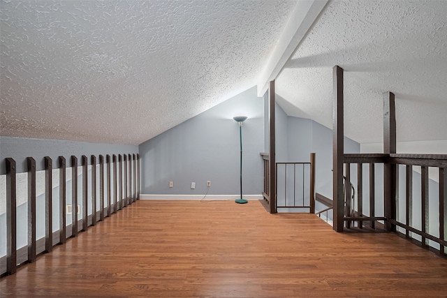 9302 Moorfield Ct, Houston, TX 77083 - additional living space featuring a textured ceiling, wood finished floors, and vaulted ceiling