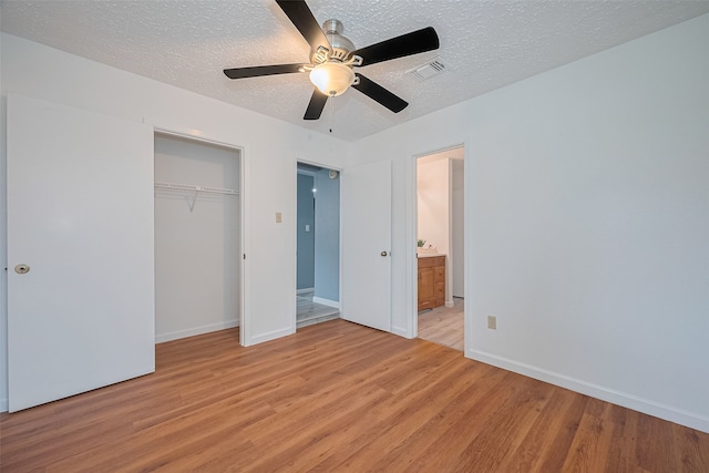 9302 Moorfield Ct, Houston, TX 77083 - unfurnished bedroom with light wood-style floors, a textured ceiling, a closet, and ceiling fan