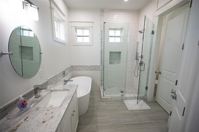 18414 Indian Beach Ct, Galveston, TX 77554 - full bathroom featuring vanity, a stall shower, and a soaking tub