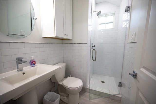 18414 Indian Beach Ct, Galveston, TX 77554 - full bath featuring a shower stall, tile walls, and a wainscoted wall