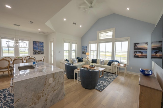 18414 Indian Beach Ct, Galveston, TX 77554 - living room featuring light wood-type flooring, ceiling fan, high vaulted ceiling, plenty of natural light, and recessed lighting