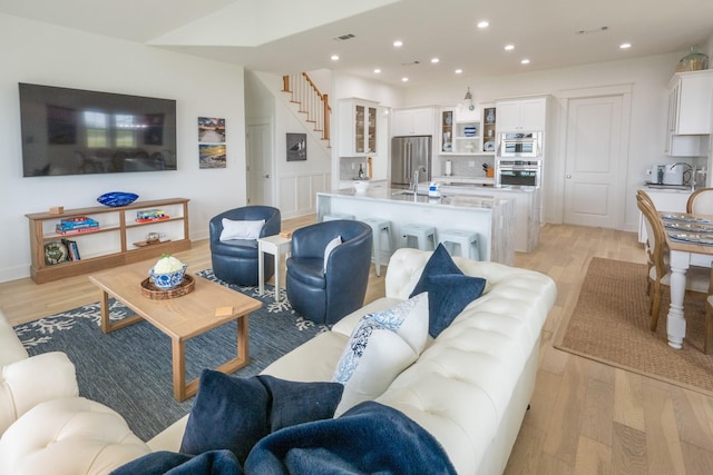 18414 Indian Beach Ct, Galveston, TX 77554 - living area with light wood-type flooring, stairs, and recessed lighting