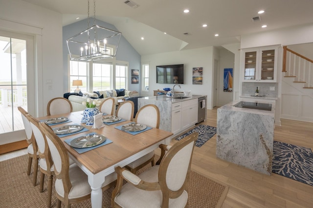 18414 Indian Beach Ct, Galveston, TX 77554 - dining area with light wood-style flooring, vaulted ceiling, plenty of natural light, recessed lighting, and stairway