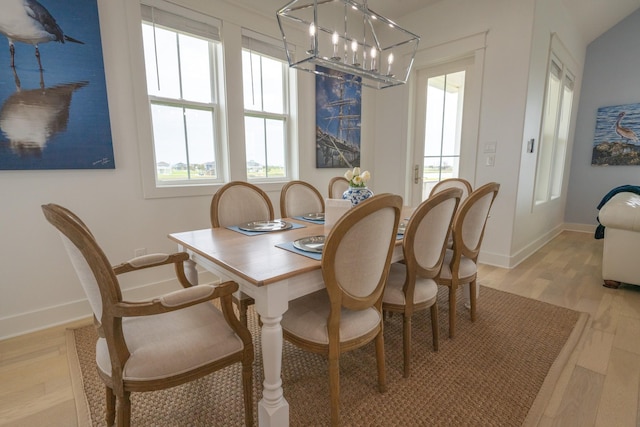 18414 Indian Beach Ct, Galveston, TX 77554 - dining room featuring a chandelier and light wood finished floors