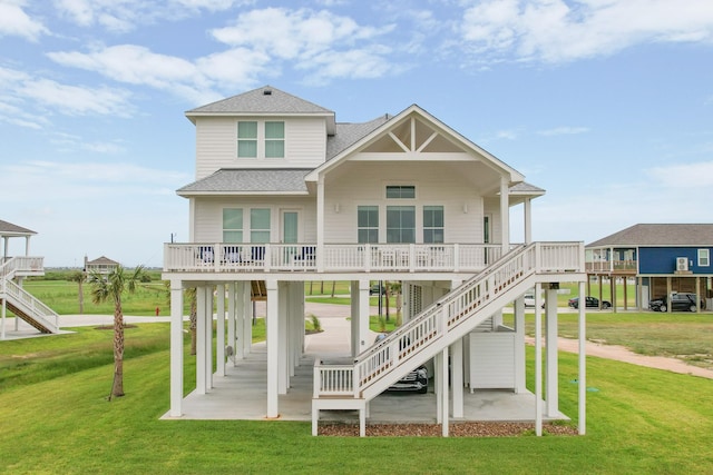 18414 Indian Beach Ct, Galveston, TX 77554 - view of front of property with roof with shingles, stairs, and a front lawn
