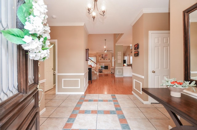 15915 Sweetwater Creek Dr, Houston, TX 77095 - foyer featuring light tile patterned floors, ornamental molding, wainscoting, a chandelier, and ceiling fan