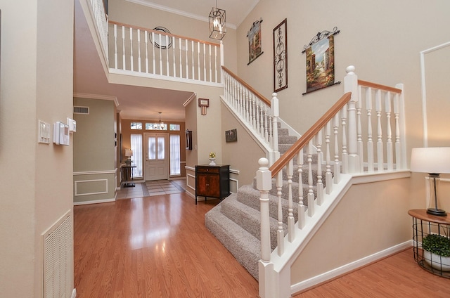 15915 Sweetwater Creek Dr, Houston, TX 77095 - foyer entrance with ornamental molding, wood finished floors, stairs, a high ceiling, and a chandelier