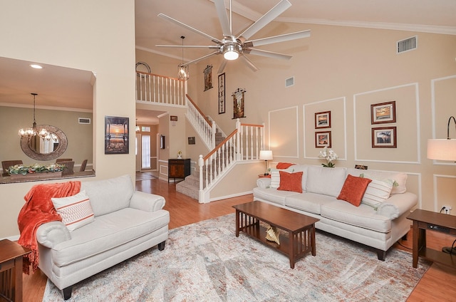 15915 Sweetwater Creek Dr, Houston, TX 77095 - living area with high vaulted ceiling, ceiling fan, wood finished floors, a chandelier, and stairway