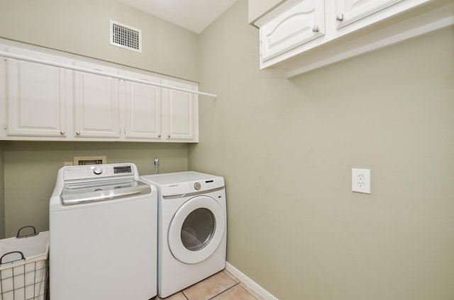 15915 Sweetwater Creek Dr, Houston, TX 77095 - laundry area featuring cabinet space, separate washer and dryer, and light tile patterned flooring