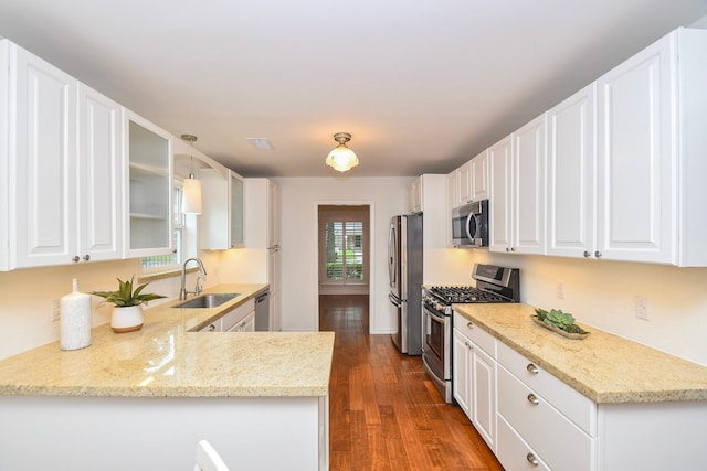 10035 Ella Lee Ln, Houston, TX 77042 - kitchen featuring appliances with stainless steel finishes, glass insert cabinets, dark wood-style floors, and white cabinetry