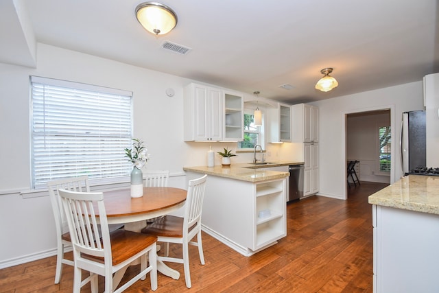 10035 Ella Lee Ln, Houston, TX 77042 - kitchen with open shelves, appliances with stainless steel finishes, dark wood-style flooring, and white cabinets