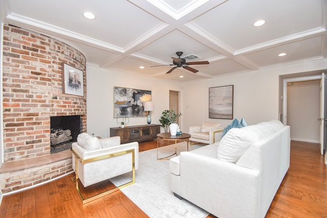 10035 Ella Lee Ln, Houston, TX 77042 - living room featuring wood-type flooring, ceiling fan, a brick fireplace, coffered ceiling, and beamed ceiling