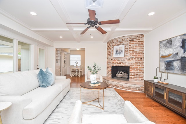 10035 Ella Lee Ln, Houston, TX 77042 - living area featuring coffered ceiling, wood finished floors, ornamental molding, a ceiling fan, and a brick fireplace