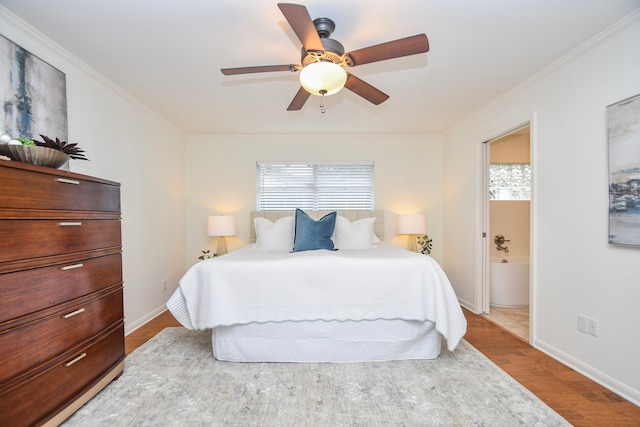 10035 Ella Lee Ln, Houston, TX 77042 - bedroom with ornamental molding, wood finished floors, connected bathroom, and ceiling fan