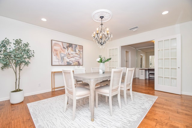 10035 Ella Lee Ln, Houston, TX 77042 - dining room featuring a chandelier, ornamental molding, light wood-type flooring, and recessed lighting